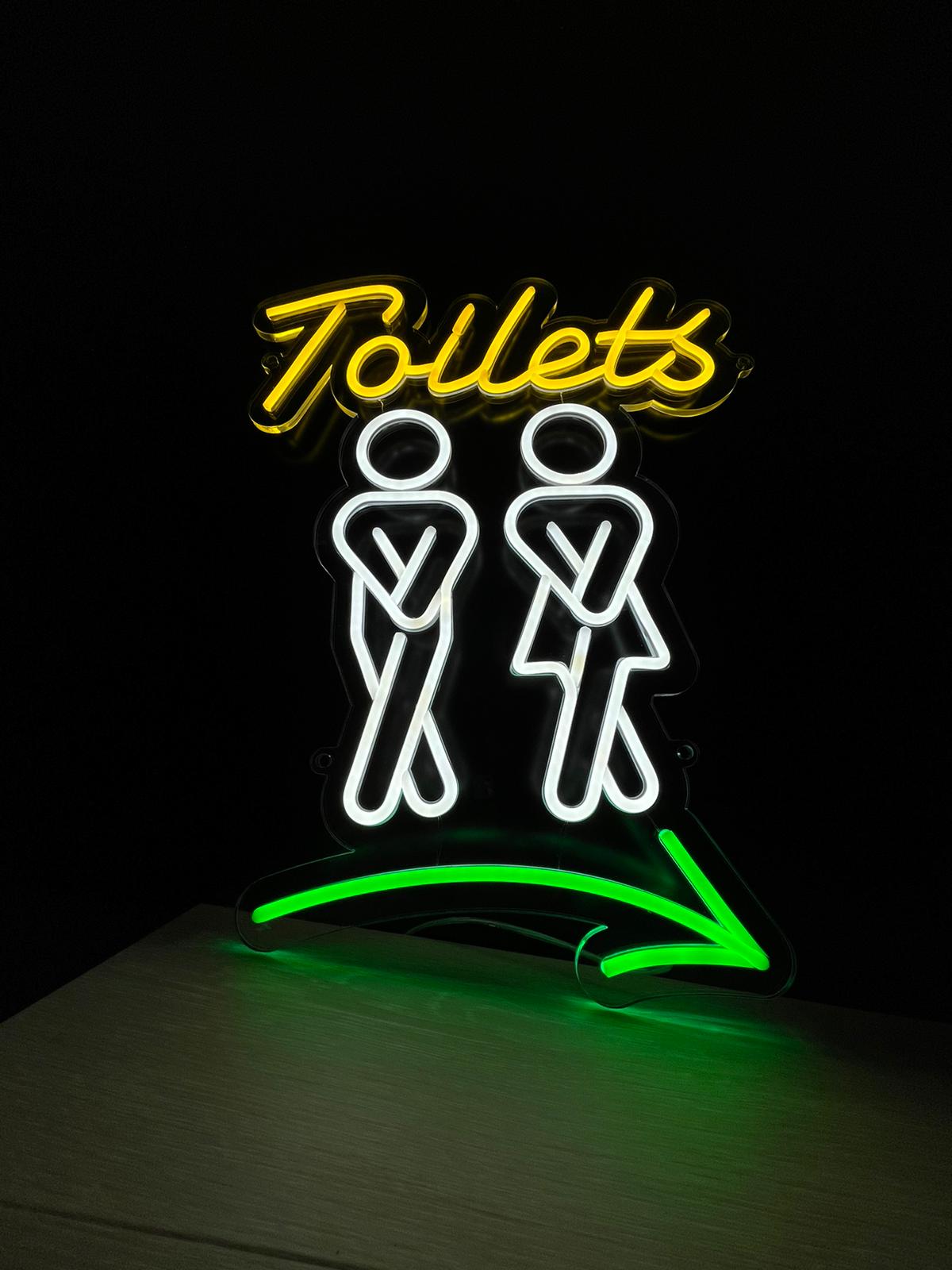 Toilets neon with figures and arrow