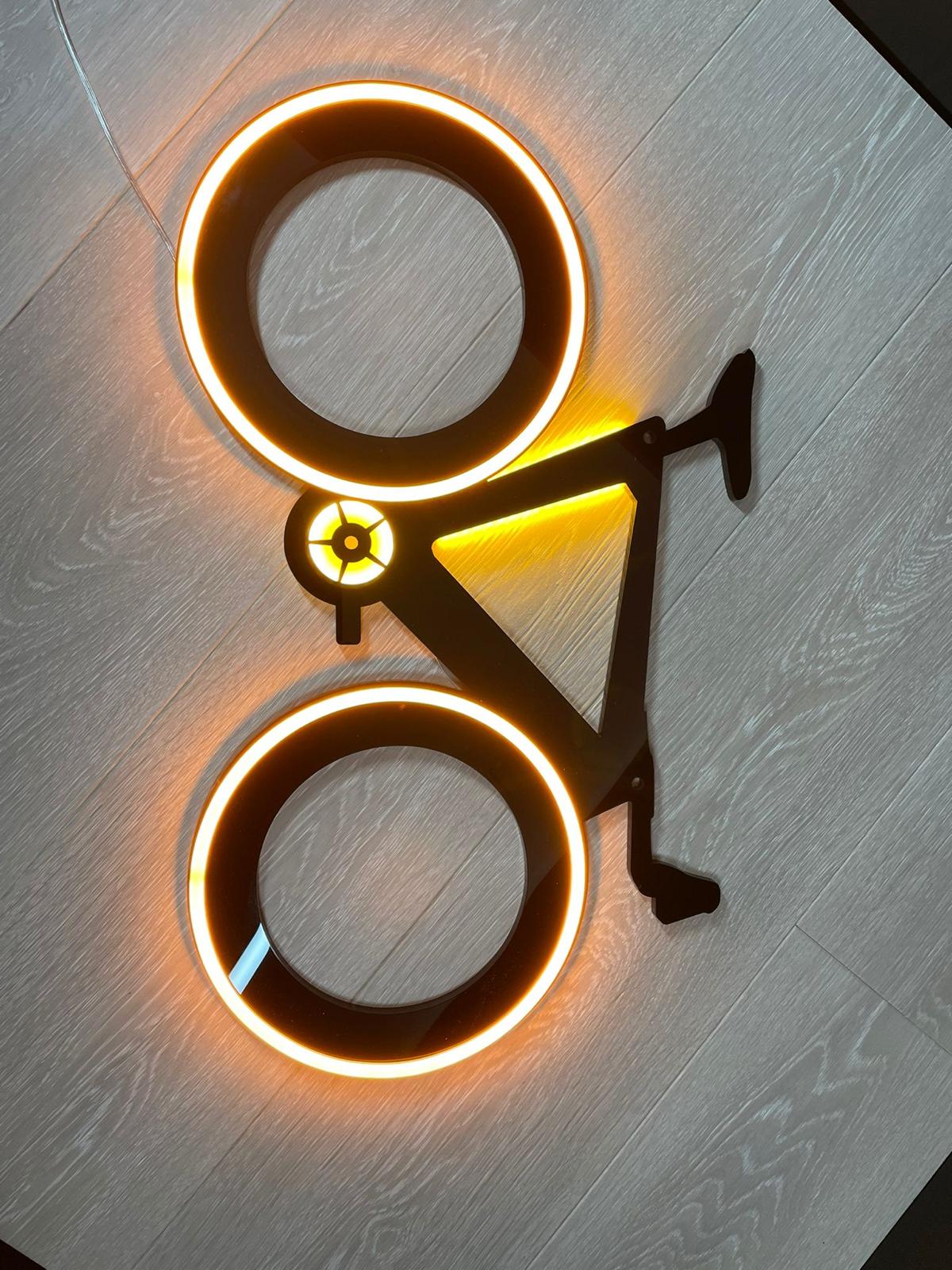 Halo-lit illuminated bicycle on wood wall