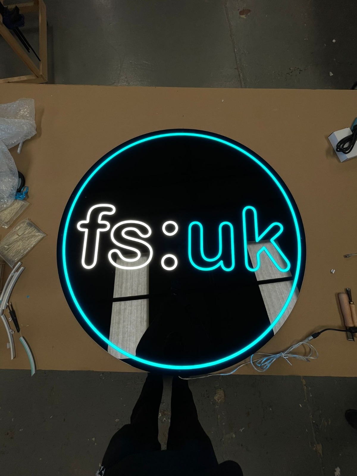 Direct Signs illuminated round sign on workshop floor