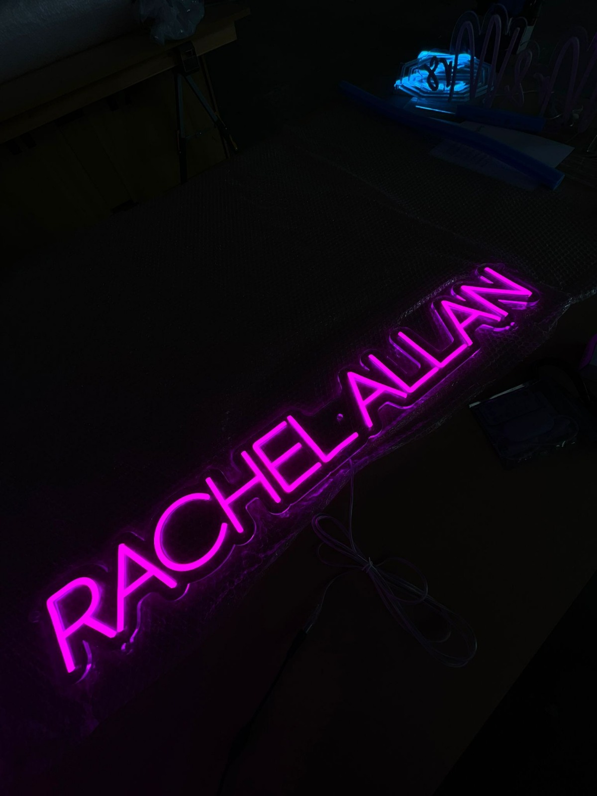 Rachel Allan pink neon on workshop bench