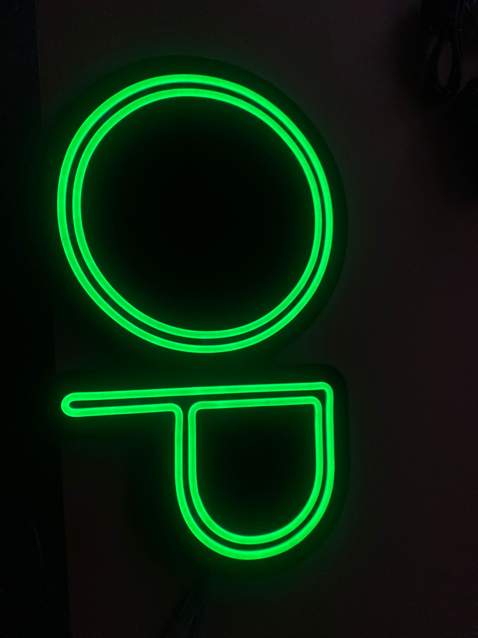 Lowercase "g" green neon detail