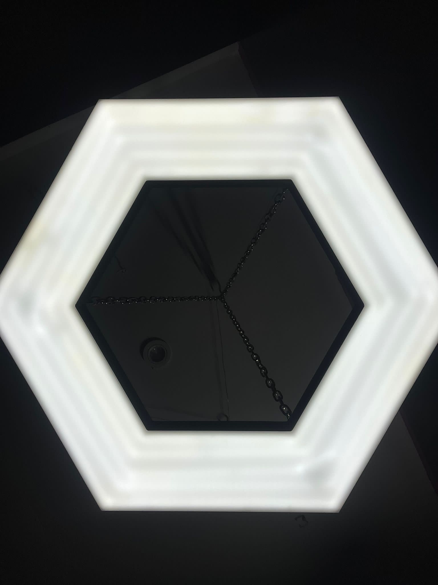 Hexagonal illuminated pendant sign ceiling view