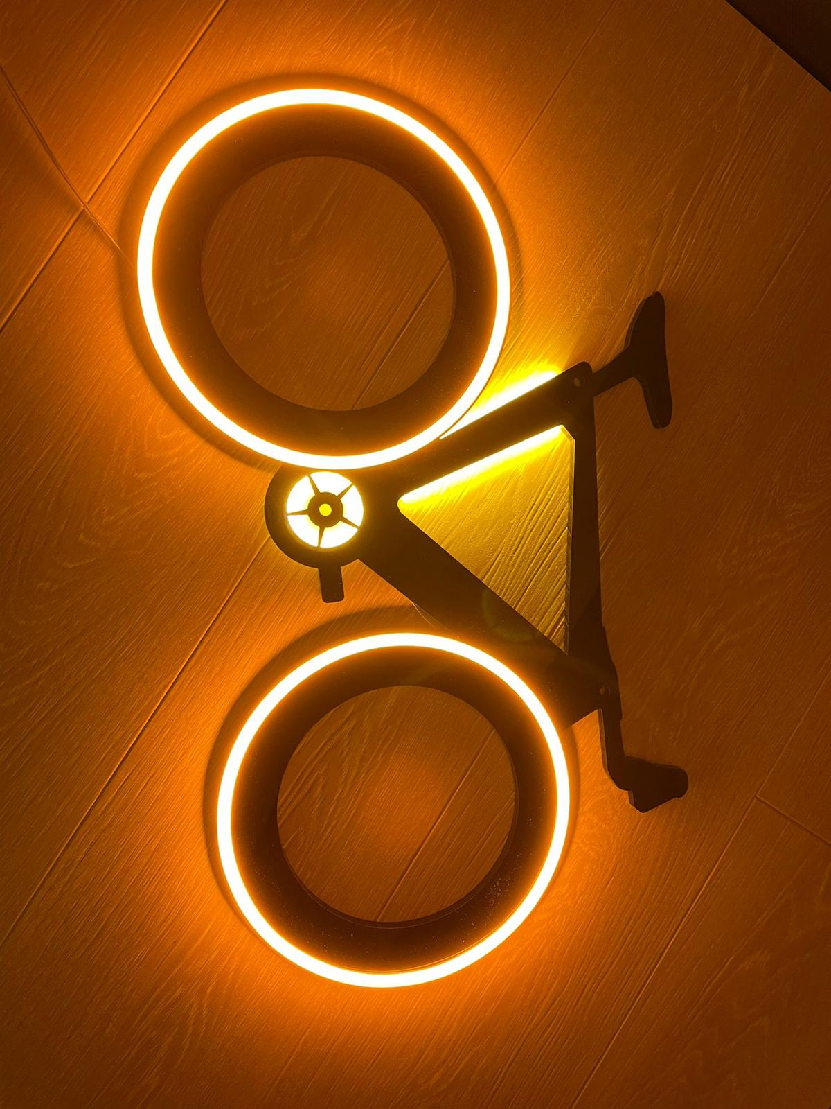 Halo-lit illuminated bicycle wall sign on wood