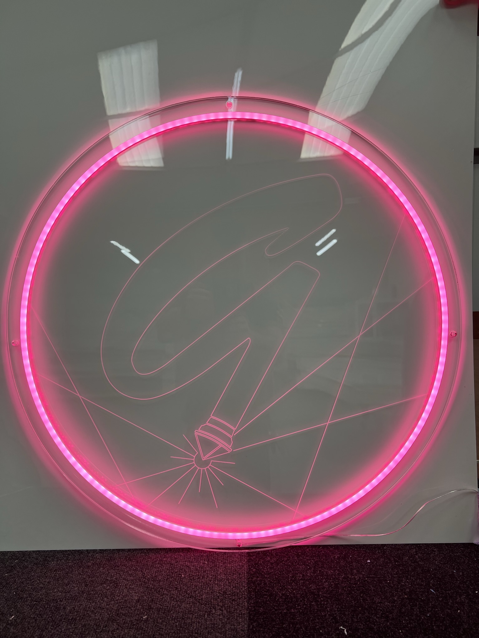 GlamCNC pink G logo LED ring sign in workshop