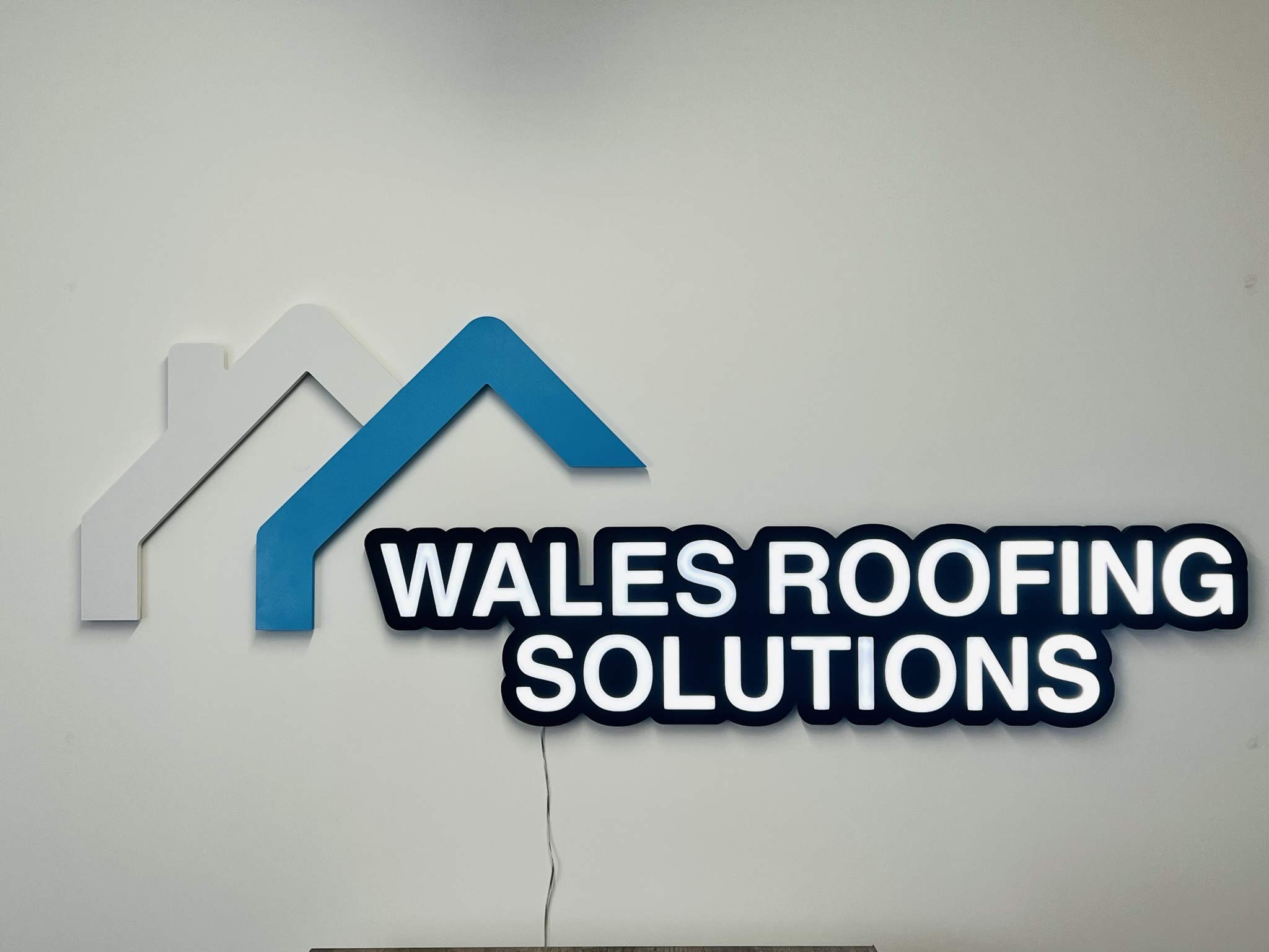 Wales Roofing Solutions illuminated wall sign