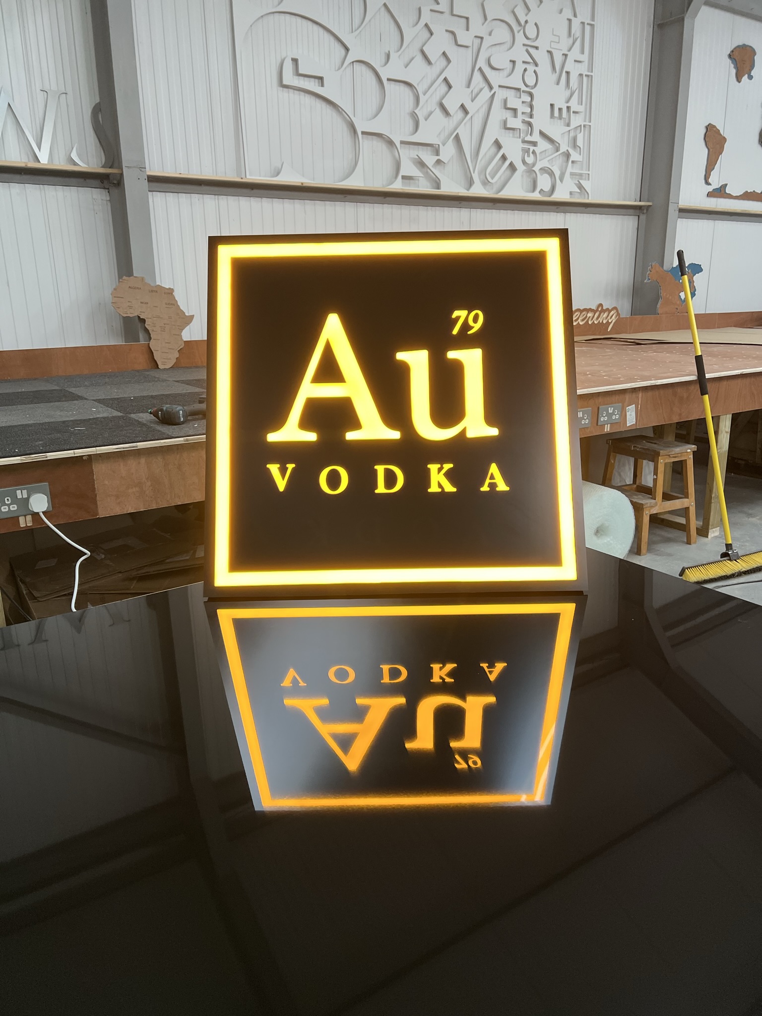 Au Vodka illuminated square sign in workshop