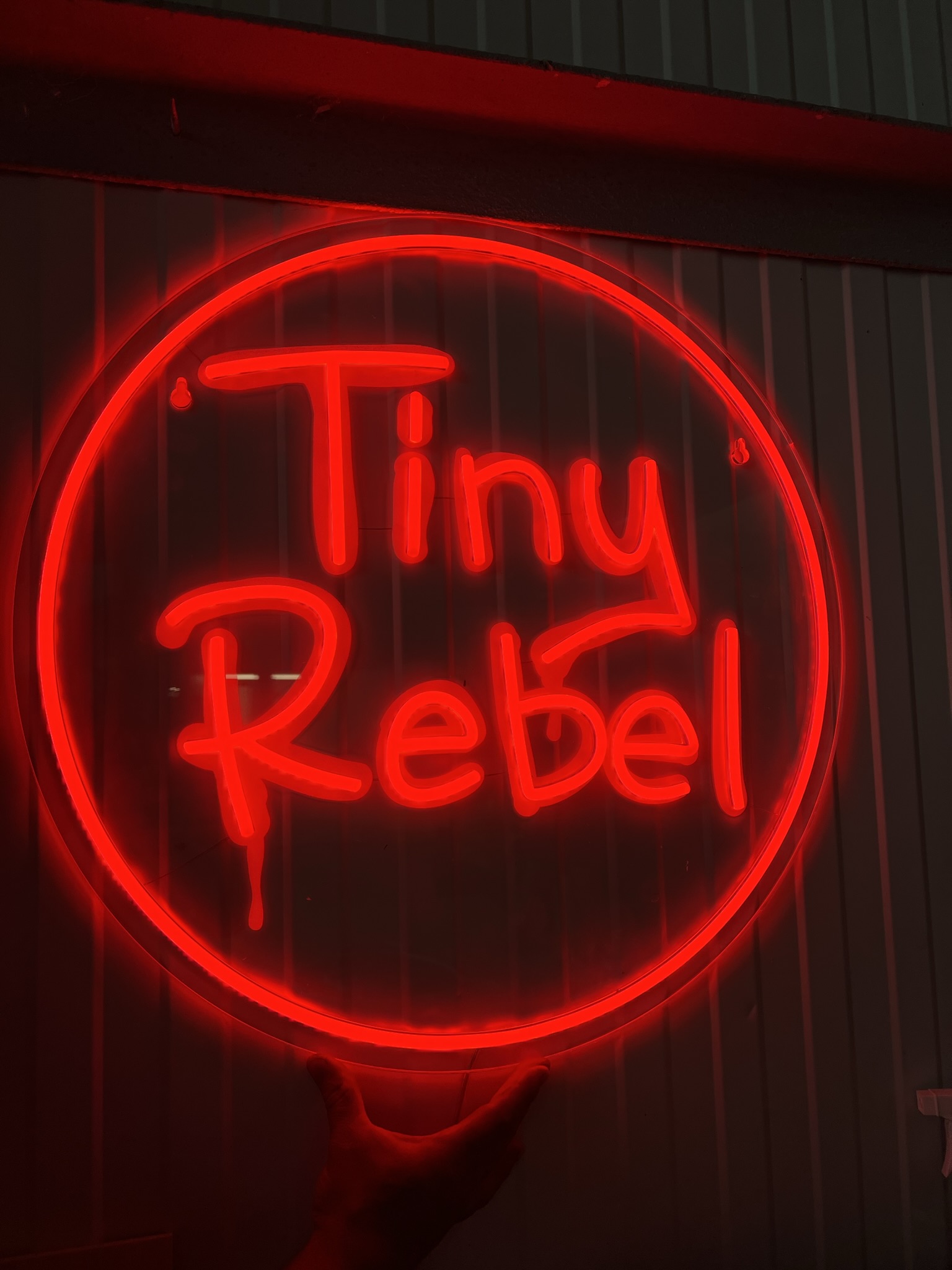 Tiny Rebel red round neon in workshop