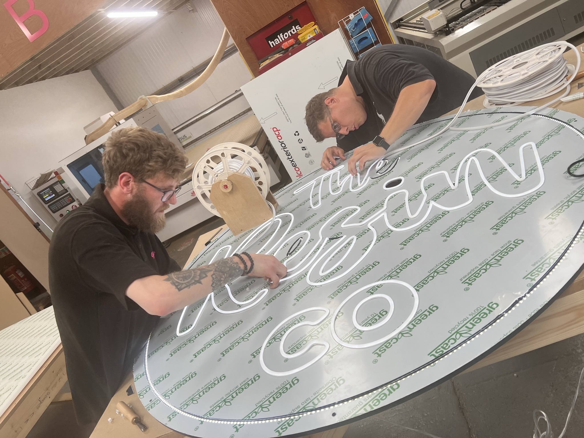 The Resin Co neon being installed by workshop staff
